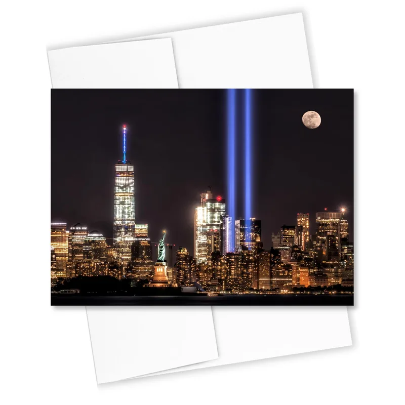 Tribute in Light Sympathy Card – Night city skyline with twin blue light beams and full moon – Greeting Card in black