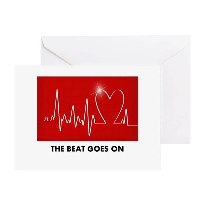 Heartbeat Love Card – Red heartbeat ECG line with white heart and THE BEAT GOES ON – Greeting Card in black