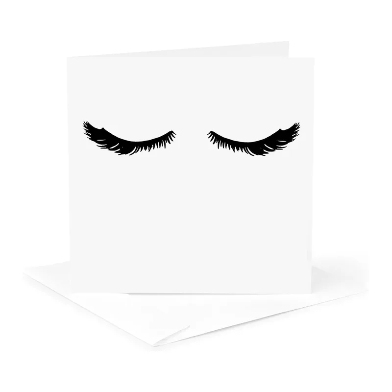 Black Eyelashes on White Card: A Minimalist Beauty Tribute